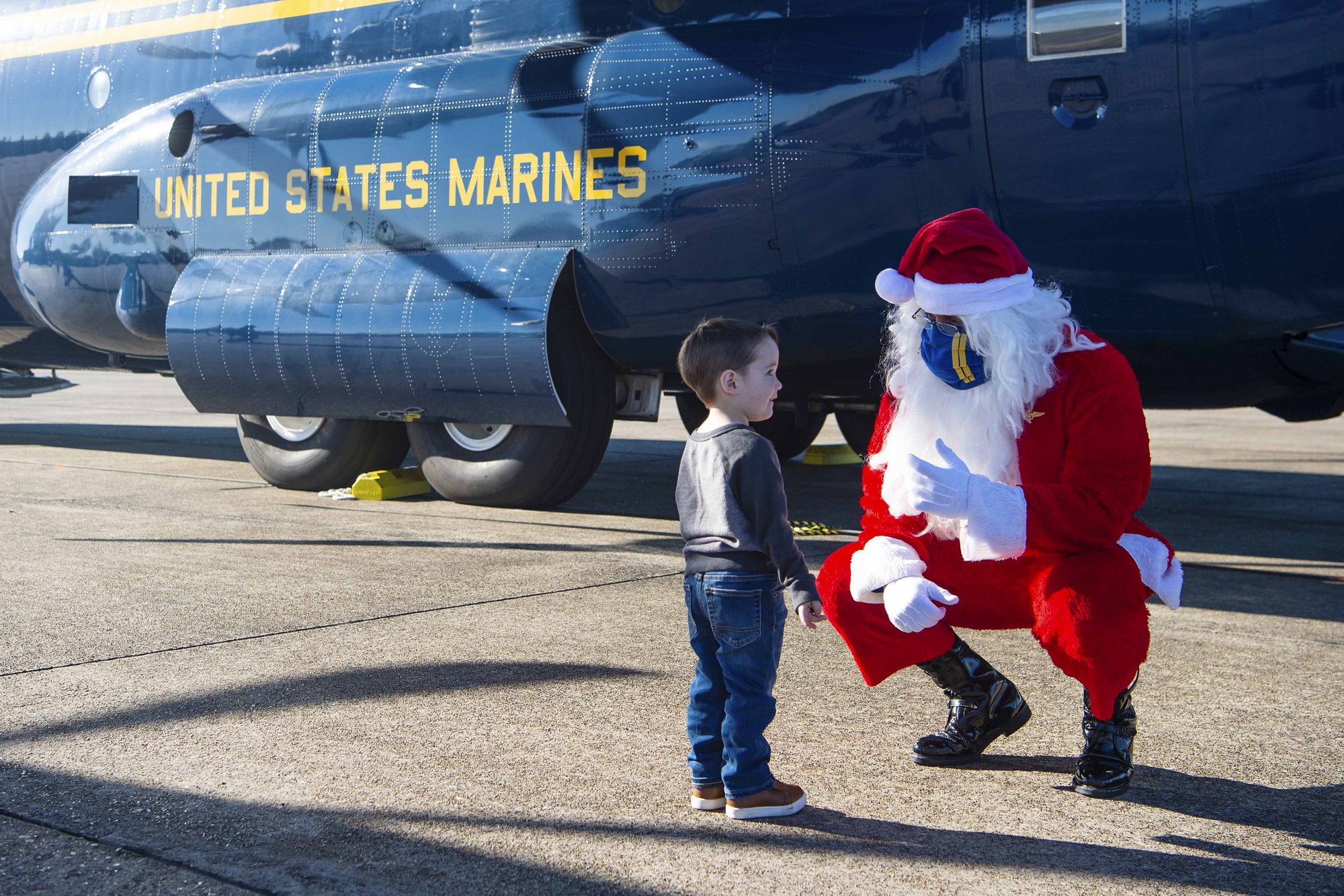 Santa speaks with a child while joining the Blue Angels, the Navy’s flight demonstration squadron, to support the Marine Corps Toys for Tots program by delivering toys and games to families impacted by the COVID-19 pandemic and multiple hurricanes in Lake Charles, La., Dec. 8, 2020. (MC2 Cody Hendrix/Navy)
