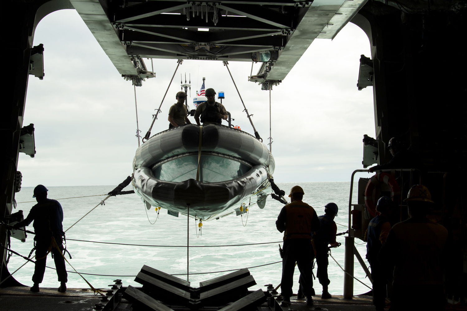 Sailors aboard the Independence-class littoral combat ship USS Gabrielle Giffords (LCS 10) lower a rigid-hulled inflatable boat in preparation for small boat operations Oct. 7, 2020, in the Pacific Ocean. (Mc2Allen Michael Amani/Navy)