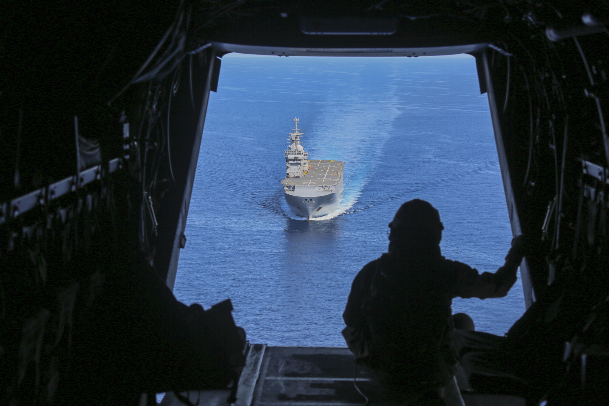 Cpl. Tyler Truong, MV-22B Osprey crew chief, observes the French Navy amphibious assault ship Mistral on June 24, 2020, in the Mediterranean Sea. (Cpl. Gary Jayne III/Marine Corps)