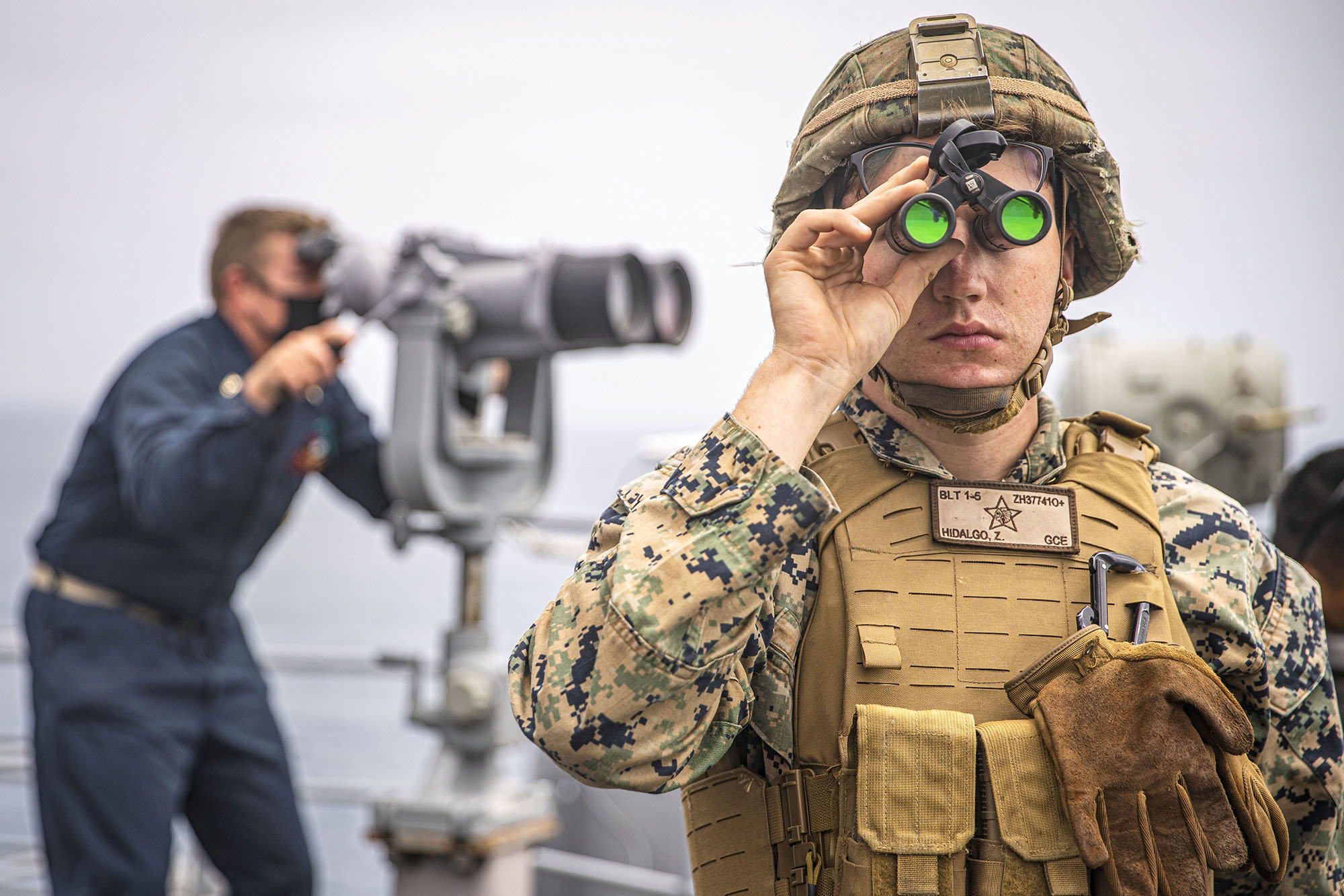 U.S. Marine Corps Lance Cpl. Zachary Hidalgo provides observation during formation April 20, 2021, steaming aboard the amphibious dock landing ship USS Pearl Harbor (LSD 52) in the Pacific Ocean. (Cpl. Jaxson Fryar/Marine Corps)