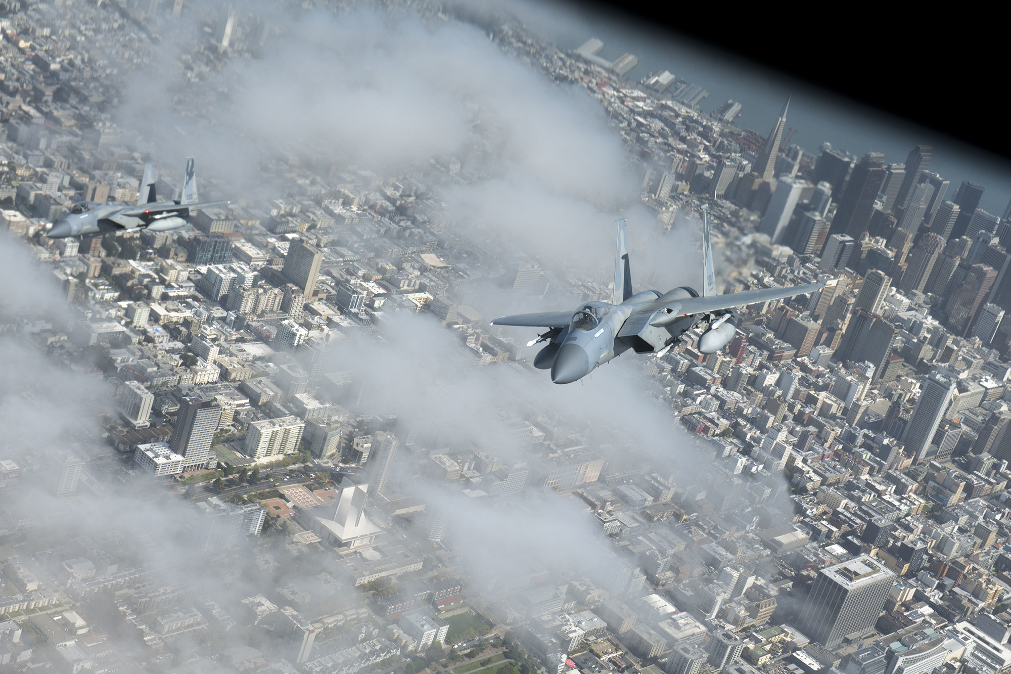 Two F-15C Strike Eagles fly in formation with a KC-135 Stratotanker during operation Noble Defender over San Francisco, April 6, 2021. Noble Defender simulated air defense of ports in California and North Carolina. (Senior Airman Lawrence Sena/Air Force)