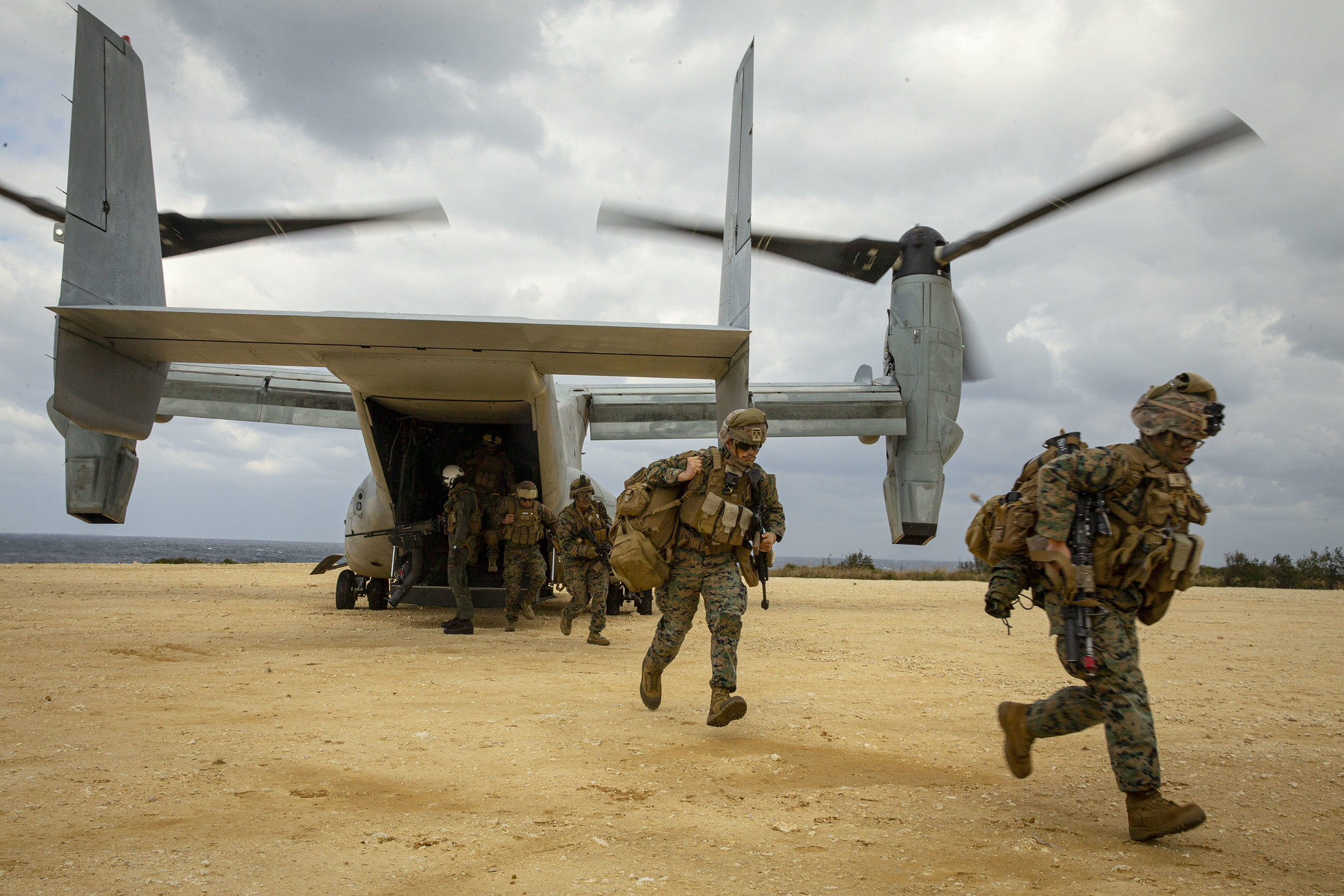 U.S. Marines run out of an MV-22B Osprey tiltrotor aircraft on Jan. 28, 2021, during an exercise on Ie Shima, Okinawa, Japan. (Cpl. Cody Rowe/Marine Corps)