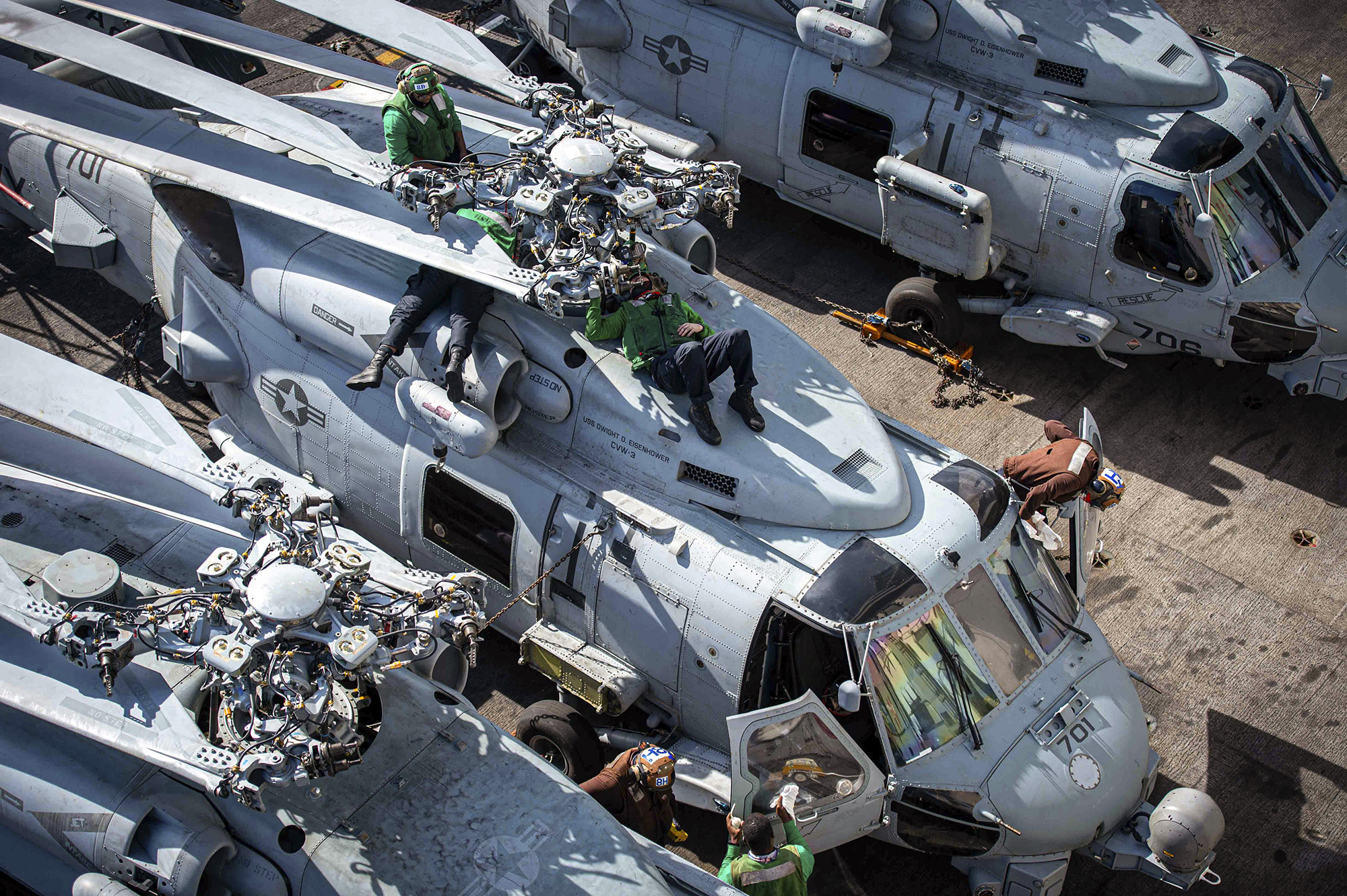 Sailors perform maintenance on an MH-60R Sea Hawk on Jan. 27, 2021, on the flight deck aboard the Nimitz-class aircraft carrier USS Dwight D. Eisenhower (CVN 69) in the Atlantic Ocean. (Mass Communication Specialist Seaman Orion Shotton/Navy)