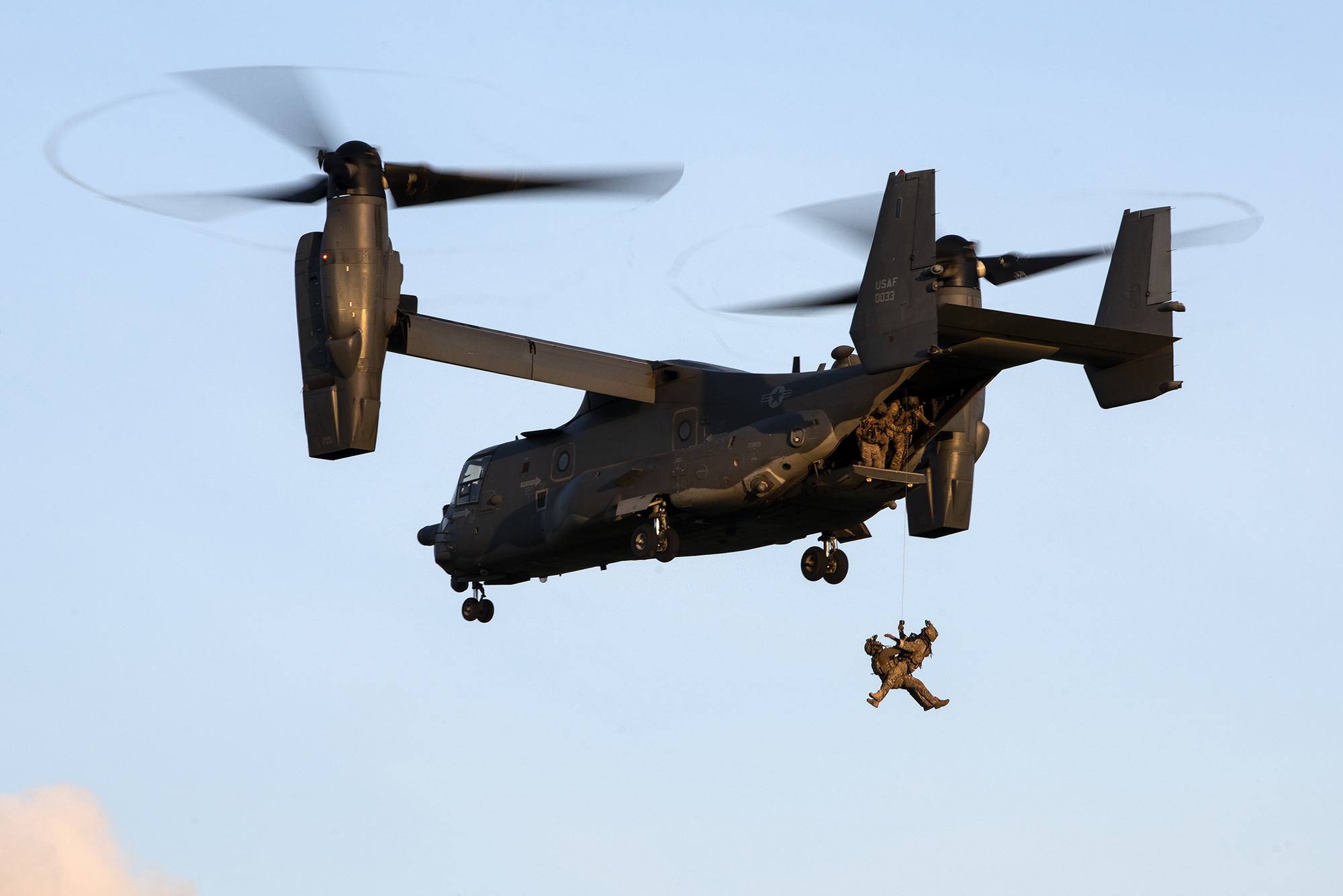 Special tactics operators assigned to the 321st Special Tactics Squadron tandem hoist into a CV-22B Osprey during a training exercise near RAF Mildenhall, United Kingdom, April 15, 2021. (Tech. Sgt. Westin Warburton/Air Force)