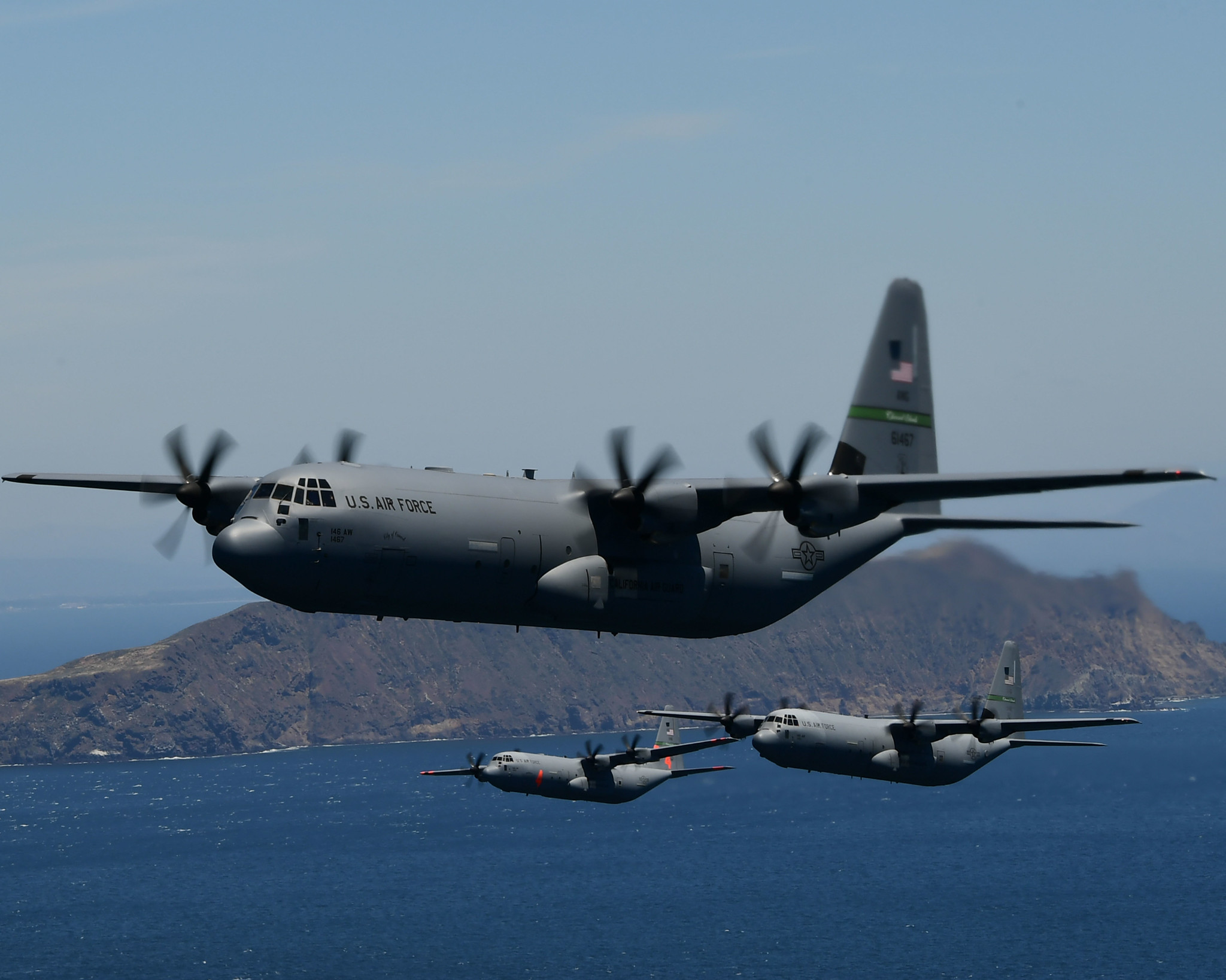 Four U.S. Air National Guard C-130J Super Hercules cargo aircraft from the California Air National Guard’s 115th Airlift Squadron, 146th Airlift Wing, Port Hueneme, California, fly in formation during low-level tactical training near Anacapa Island, Calif., May 14, 2020. The tactical training was combined with a flyover a salute by the military to honor medical professionals and other essential workers serving on the front line of the COVID-19 pandemic. (Tech. Sgt. Nieko Carzis/Air National Guard)