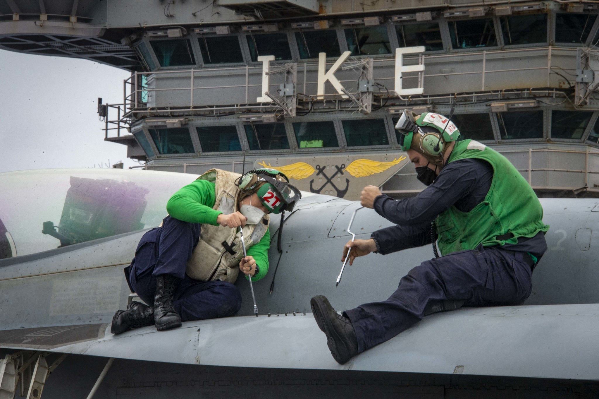 Aviation Electronics Technician 3rd Class Hongyuan Wang, left, and Aviation Electronics Technician 3rd Class Kameron Hair conduct maintenance Feb. 23, 2021, on an F/A-18E Super Hornet on the flight deck aboard the aircraft carrier USS Dwight D. Eisenhower (CVN 69) in the Atlantic Ocean. (MC3 Jairus P. Bailey/Navy)