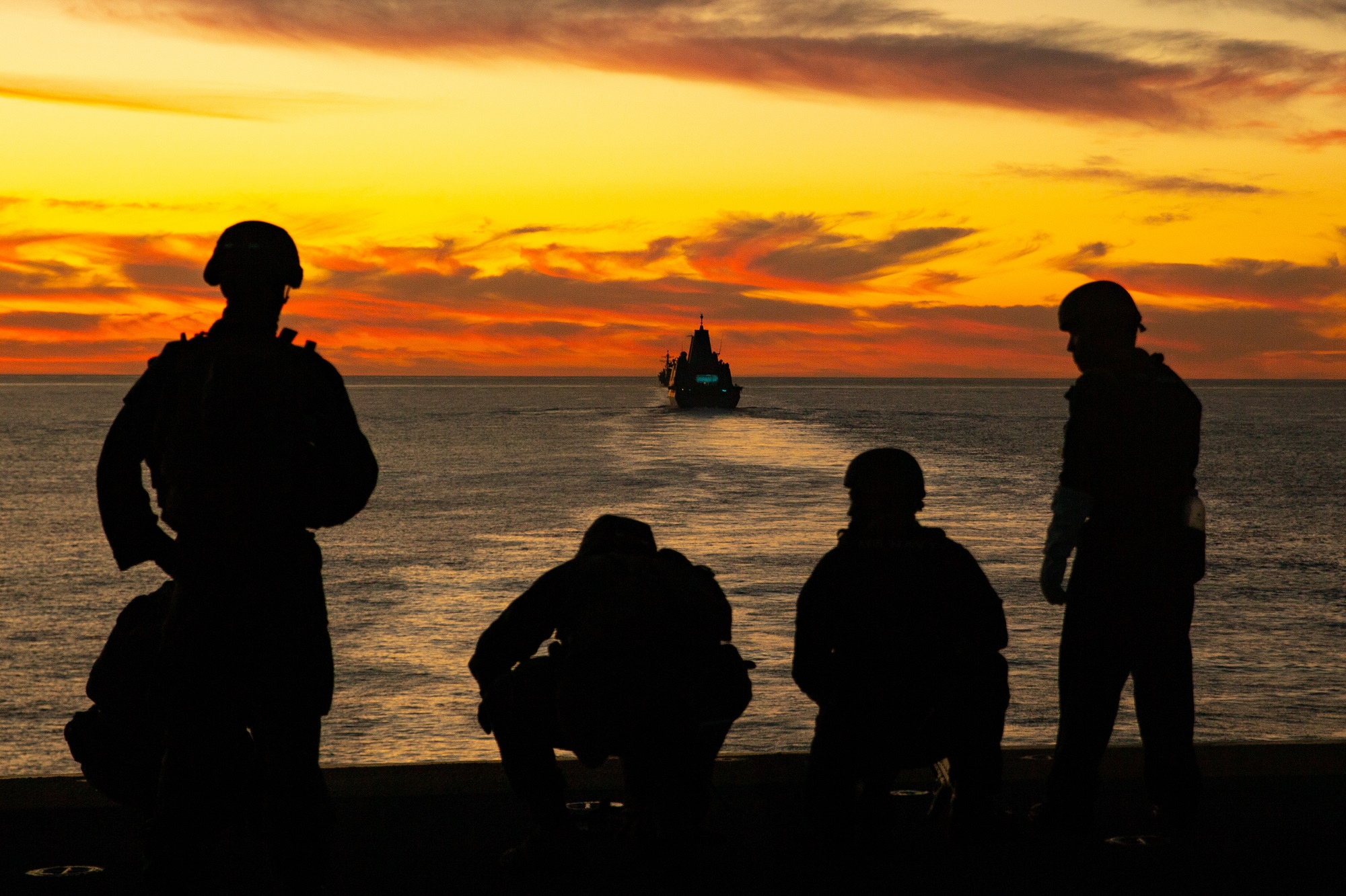 Sailors and Marines aboard the Wasp-class amphibious assault ship USS Essex (LHD-2) post security from the flight deck during exercise Steel Knight/Dawn Blitz (SK/DB) 21 off the coast of Southern California, Dec. 4, 2020. (Lance Cpl. Cameron Rowe/Marine Corps)