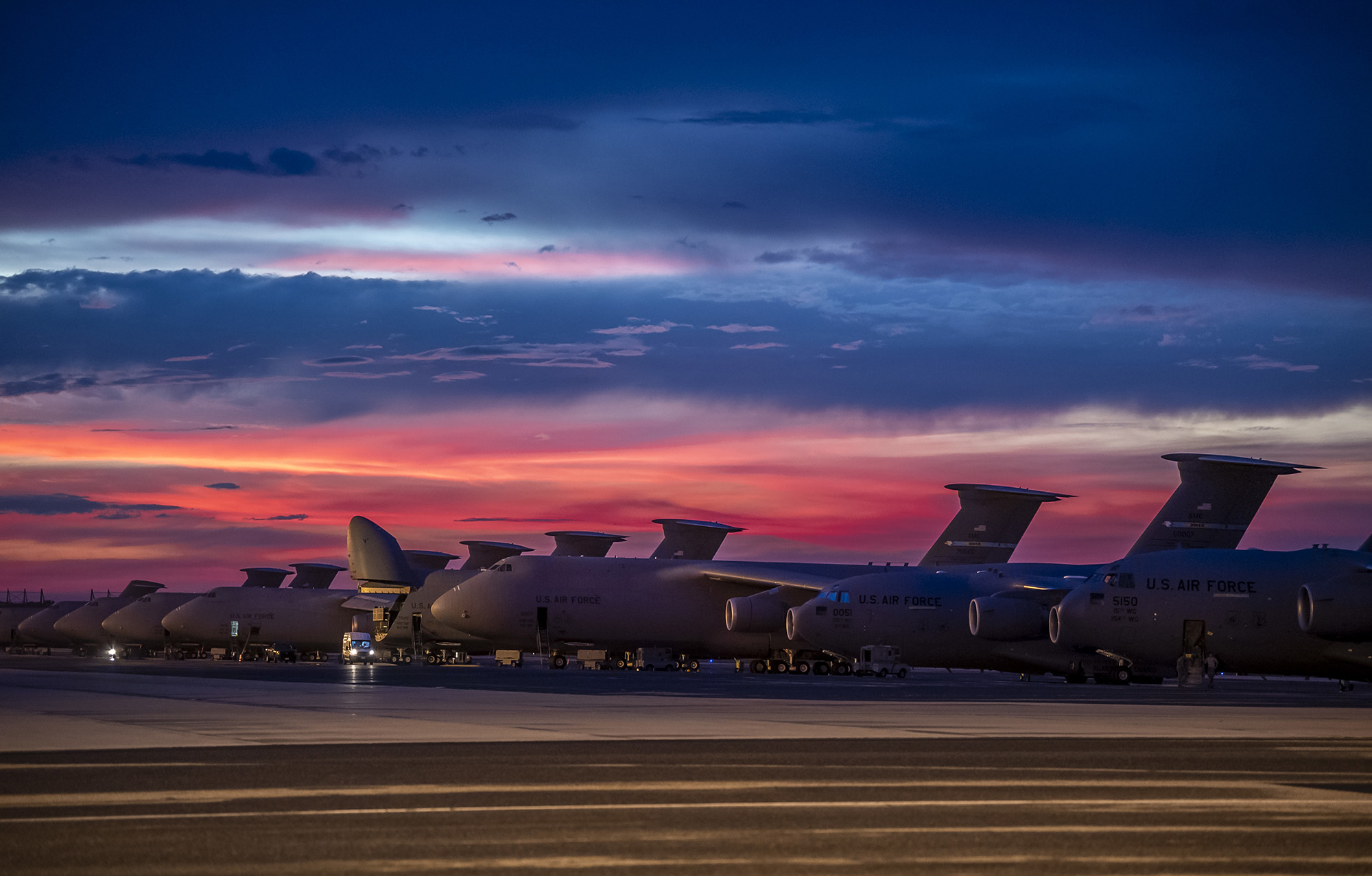 The sun sets over Dover Air Force Base, Del., as airmen work on the flightline Aug. 12, 2020. (Senior Airman Christopher Quail/Air Force)