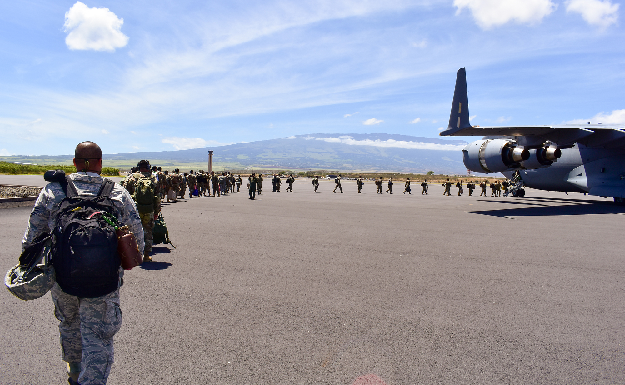 Members of the Hawaii National Guard board an aircraft home after volunteering to assist Maui County with supporting various tasks during COVID-19 operations, Kahului, Hawaii, May 28, 2020. (Sgt. 1st Class Theresa Gualdarama/Army National Guard)
