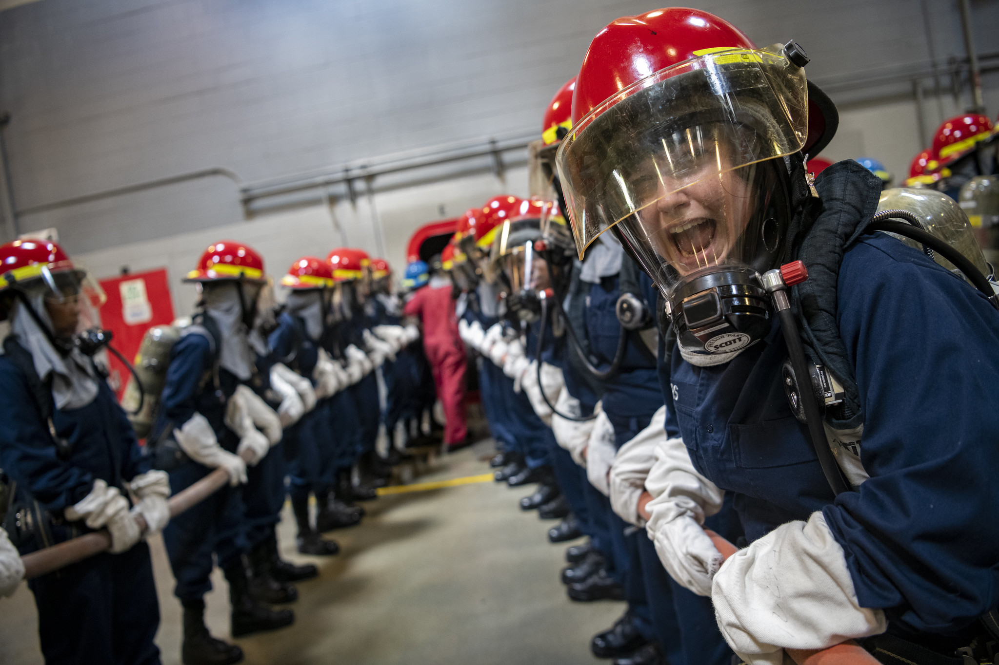 Recruits participate in firefighting and damage control training inside the USS Chief Fire Fighter Trainer on July 29, 2020, as part of the hands-on learning at Recruit Training Command at Great Lakes, Ill. (MC1 Camilo Fernan/Navy)