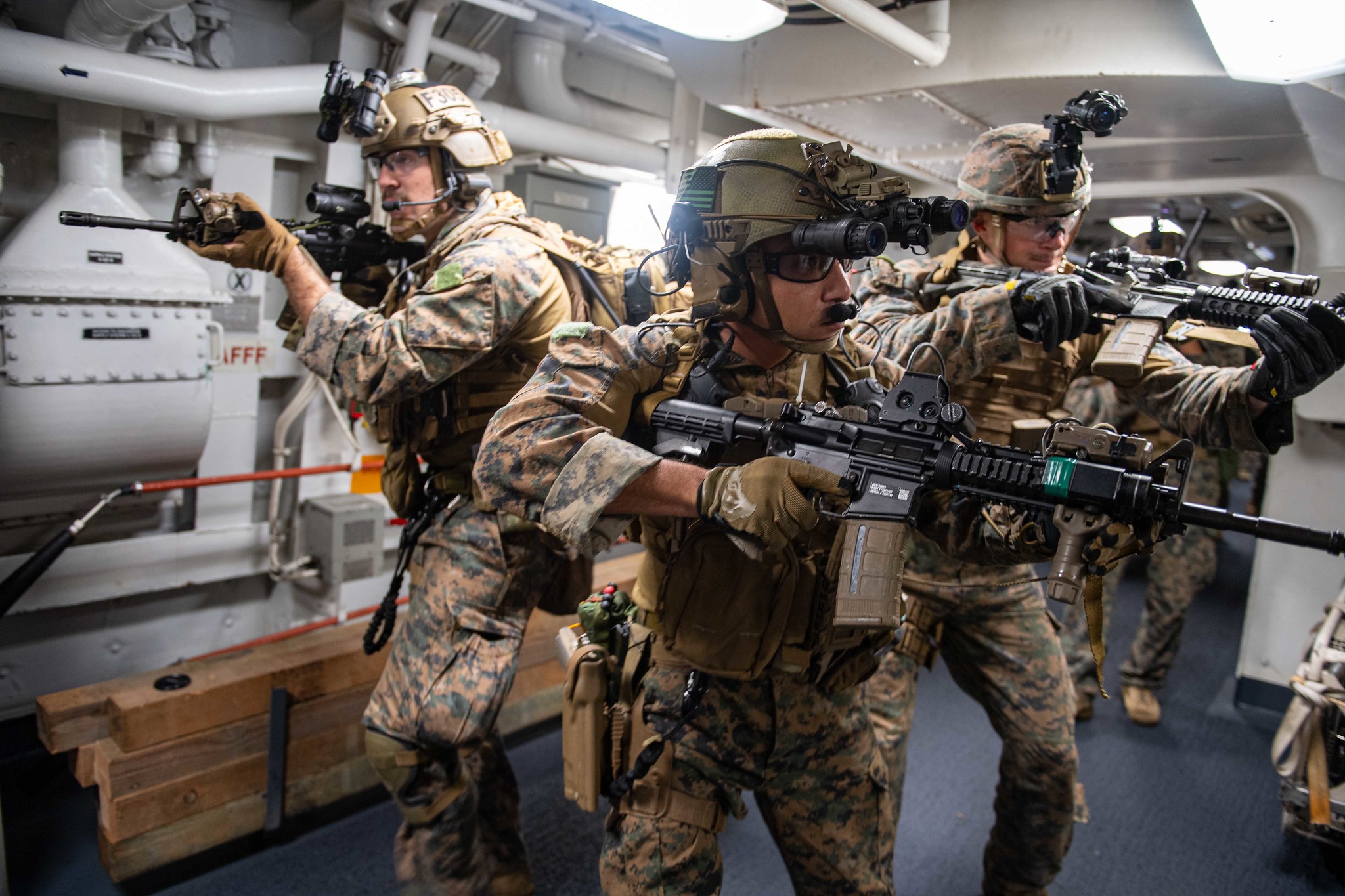 Marines attached to the 31st Marine Expeditionary Unit (MEU) search amphibious transport dock ship USS New Orleans (LPD 18) on June 14, 2021, during a maritime raid force training evolution with USS Germantown (LSD 42) in the East China Sea. (MC2 Desmond Parks/Navy)