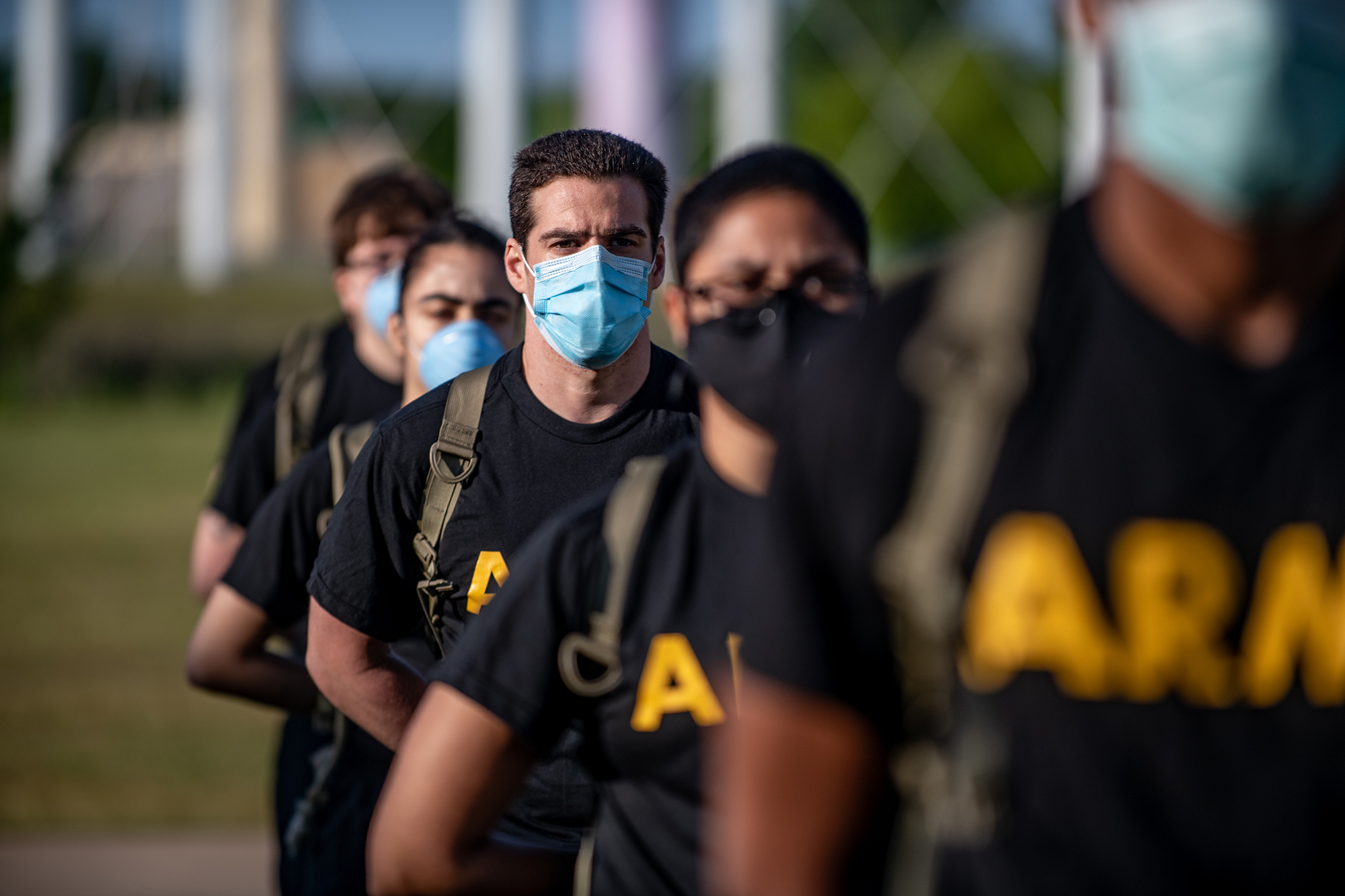 Soldiers from 95th Adjutant General Battalion, 434th Field Artillery Brigade, Fort Sill, Okla., stand in formation while wearing masks and maintaining physical distancing during reception before entering basic combat training May 14, 2020, on Fort Sill. (Sgt. Dustin D. Biven/Army)