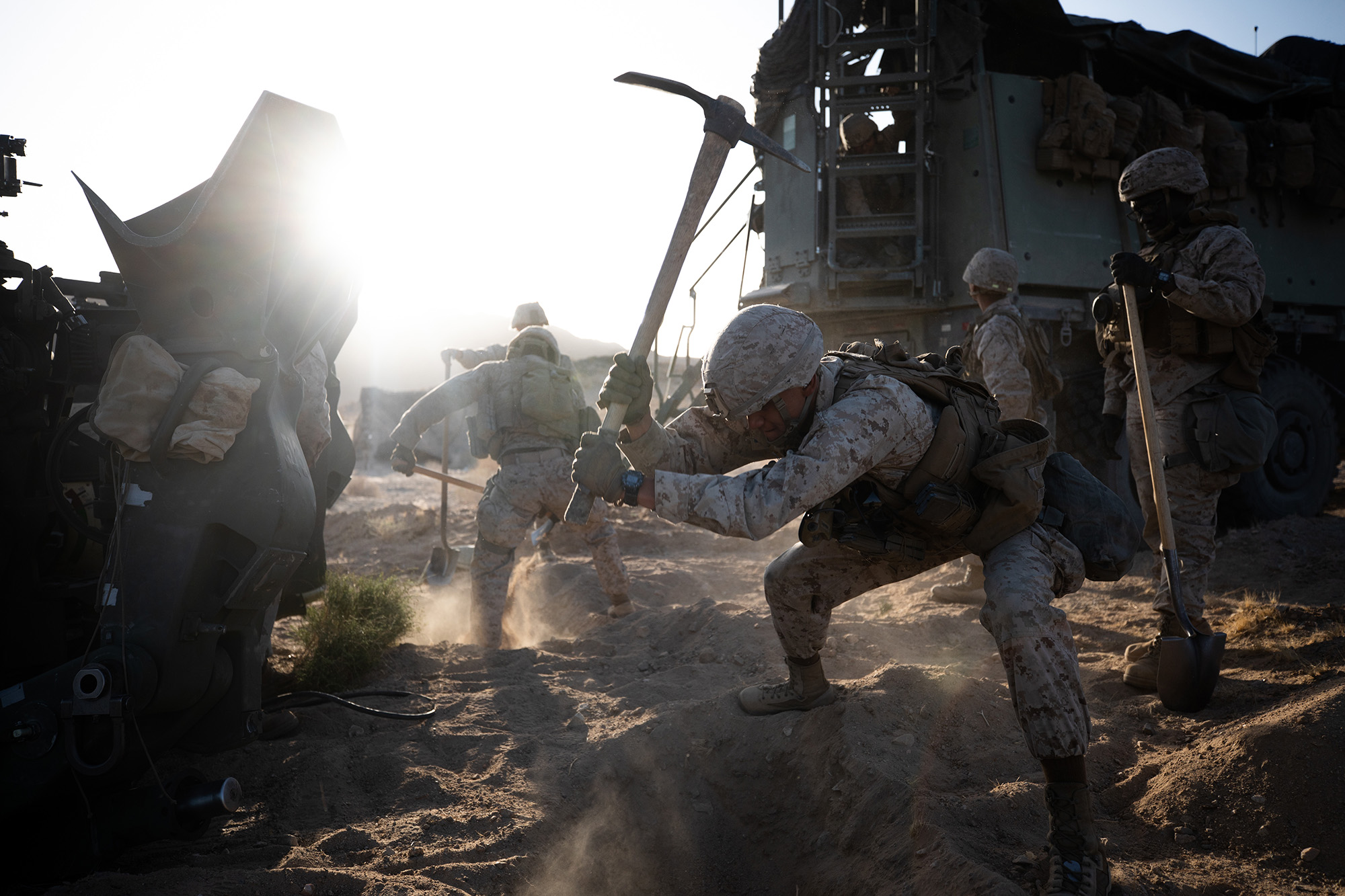 Marine Corps Pfc. Aristeo Morales digs an entrenchment for an M777 towed 155 mm howitzer during a live-fire defense simulation at the Marine Corps Air Ground Combat Center in Twentynine Palms, Calif., March 30, 2021. (Cpl. Jamin M. Powell/Marine Corps)