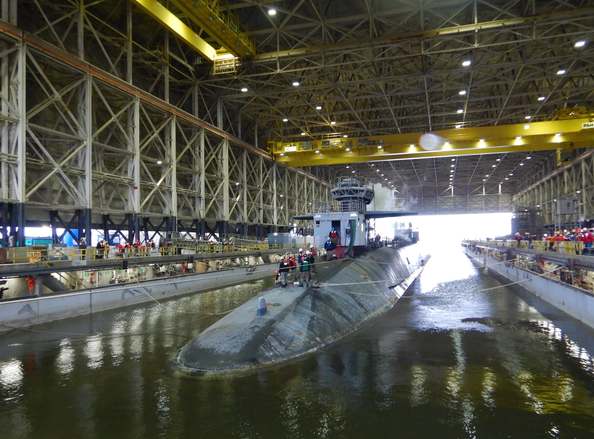 The Ohio-class ballistic-missile submarine USS Tennessee (SSBN 734) enters the Trident Refit Facility, Kings Bay, Ga., dry dock Feb. 1, 2021, for an extended refit period. Tennessee will be the last submarine in the dry dock before a $554 million dry dock refurbishment project begins later this summer. (Elaine Rilatt/Navy)