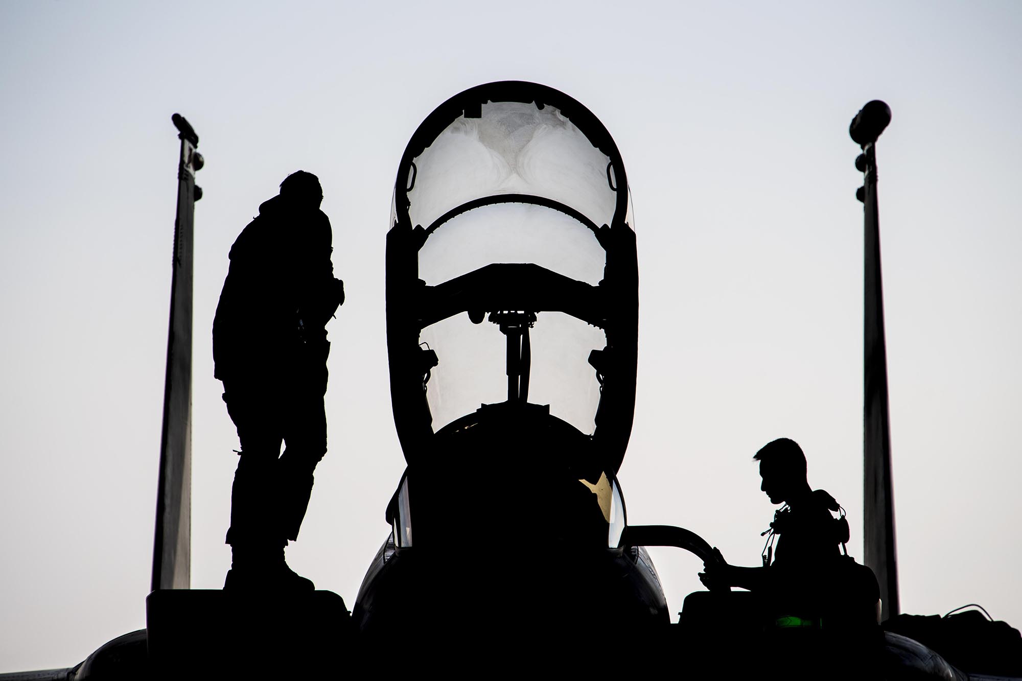 Air Force Capt. Ryan Heil and a maintainer assigned stand on an F-15E Strike Eagle shortly after landing at Al Dhafra Air Base, United Arab Emirates, Feb 13, 2021. (Senior Airman Aaron Larue Guerrisky/Air Force)