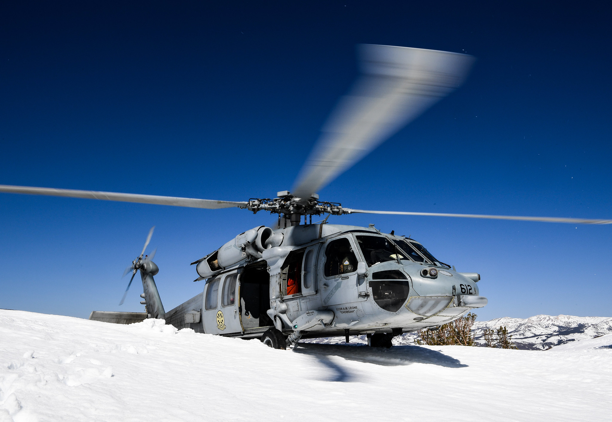 An MH-60S Seahawk helicopter lands in the snow during high-altitude landing training, hosted by Naval Aviation Warfighting Development Center (NAWDC) at Naval Air Station Fallon, Nev., on April 1, 2021. (Chief Mass Communication Specialist Shannon Renfroe/Navy)