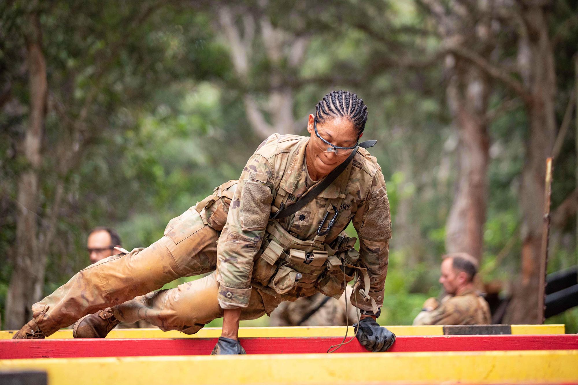 Lt. Col. Paula Young, Brigade Surgeon, 25th Infantry Division Sustainment Brigade, hurdles over an obstacle during the Green Mile, a physical endurance course that concludes the final week of Jungle Operations Training Course at East Range, Hawaii, on Oct. 1, 2020. (1st Lt. Angelo Mejia/Army)