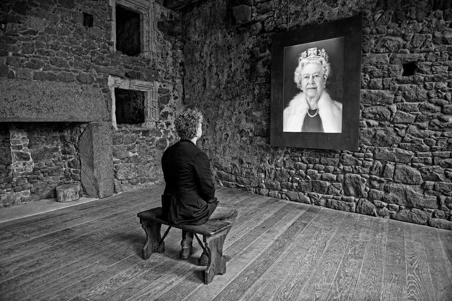 Artist Chris Levine looks at the Queen's holographic portrait at Mont Orgueil