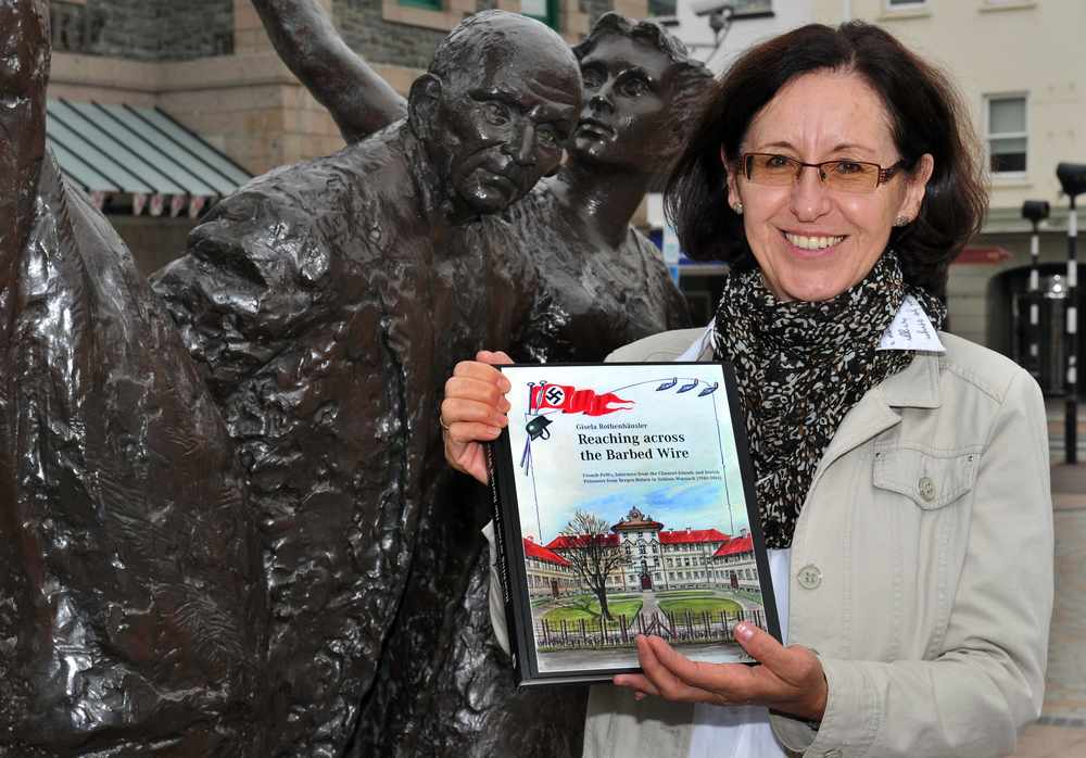 Gisela Rothenhausler at Liberation Square, with her book, Reaching Across the Barbed Wire