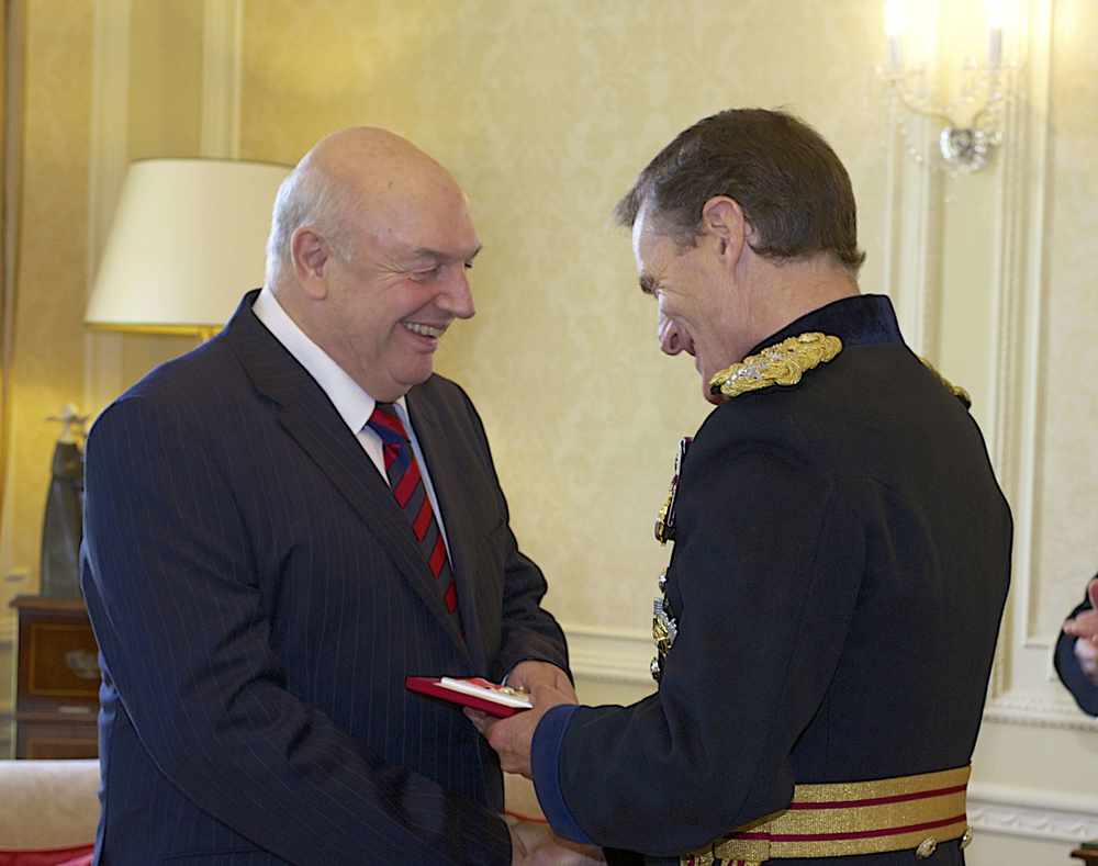 Ernie Mallett receiving the British Empire Medal at Government House from Sir John McColl