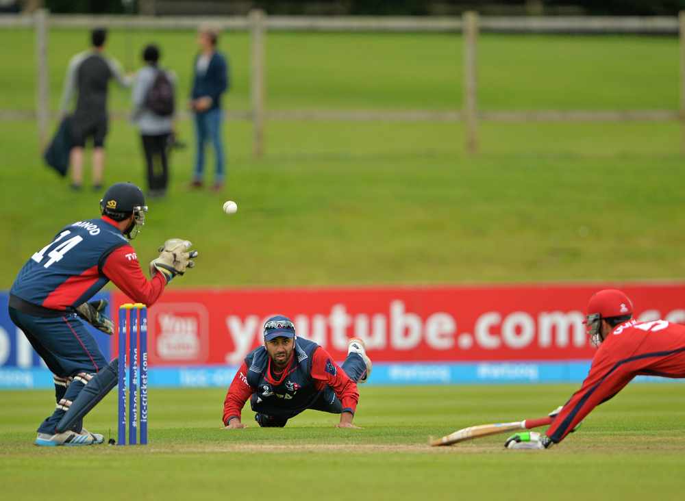 Jersey skipper Peter Gough dives for the crease