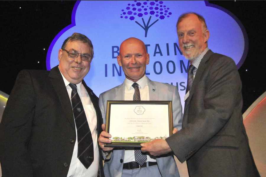 Jeff Hathaway and Constable Steve Pallett receive St Brelade's award from Jeff Bates (right) the vice chairman of the RHS Britain in Bloom Judging Panel