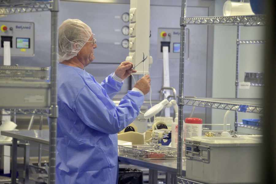 Dennis Channing examining scissors in the sterilisation room