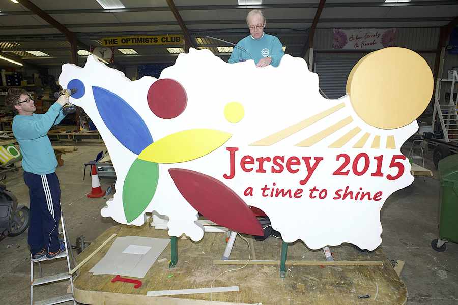 Paul Michel (left) and Steve Bouchard work on the float for the Island Games