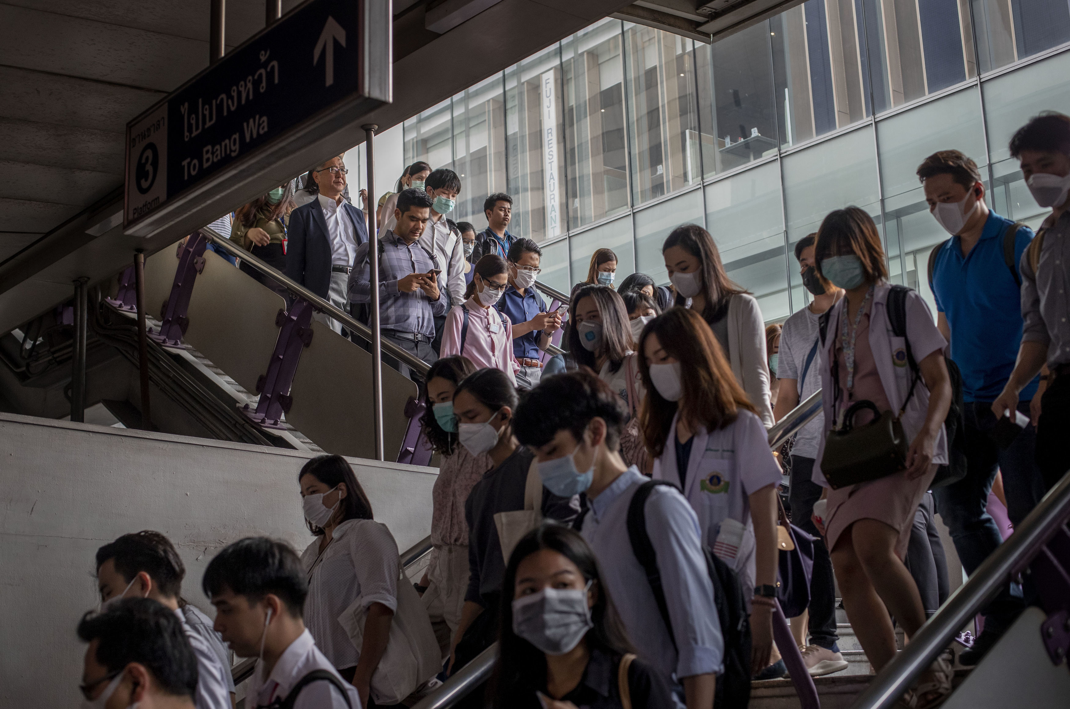 Commuters wear face masks to protect themselves from air pollution and the spreading coronavirus in Bangkok, Thailand, Tuesday, Feb. 4, 2020. On Tuesday, the Korea Centers for Disease Control and Prevention said a 42-year-old South Korean woman tested positive for the virus, days after she returned from a trip to Thailand with chills and other symptoms. (AP Photo/Gemunu Amarasinghe). (27075766)