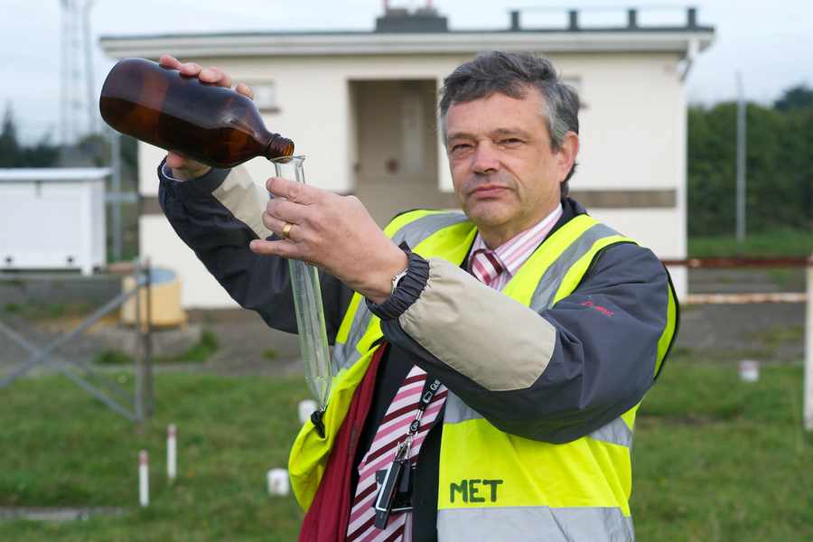 Tony Pallot in 2011 with rain gauge equipment at Jersey Airport