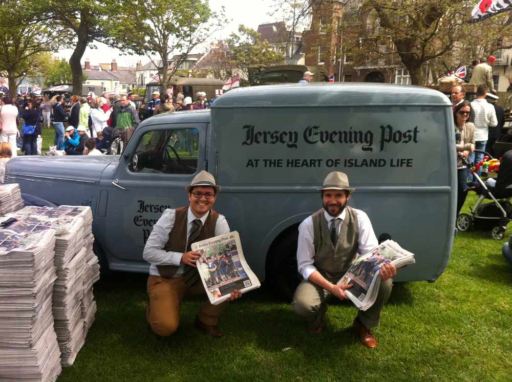 The JEP's Toby Chiang and Ramsay Cudlipp hand out copies of the Liberation 70 commemorative edition of the Jersey Evening Post in People's Park