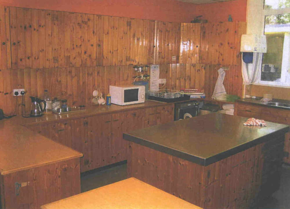 The kitchen is fitted out with wood panelling