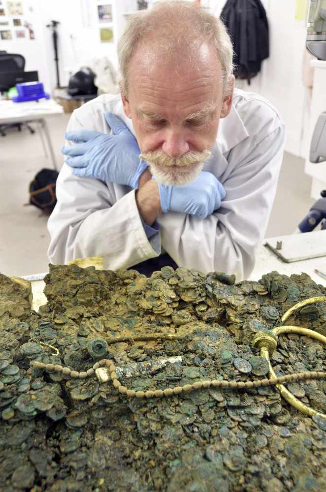Museum conservator Neil Mahrer ponders the next move in removing the jewellery