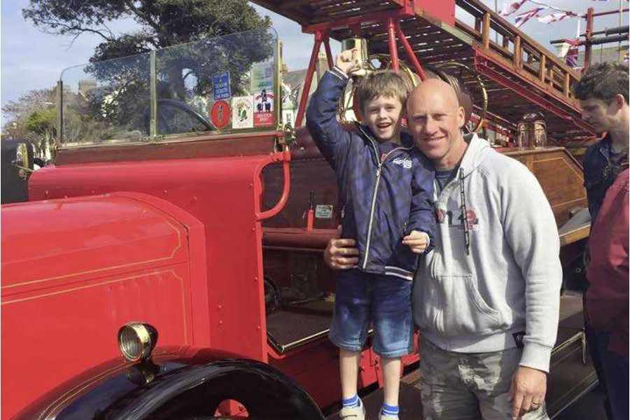 George Sellars (5) inspects a 1934 fire engine with his father, Andy