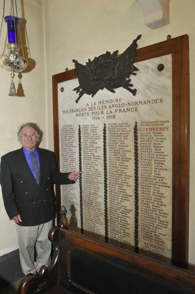 Mr Le Bail points to his uncle's name on the memorial in St Thomas' Church