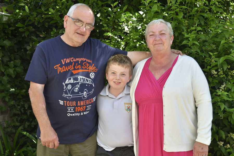 John and Pauline Vallois, pictured with their grandson Liam, have been nominated for their continued support of their eight grandchildren