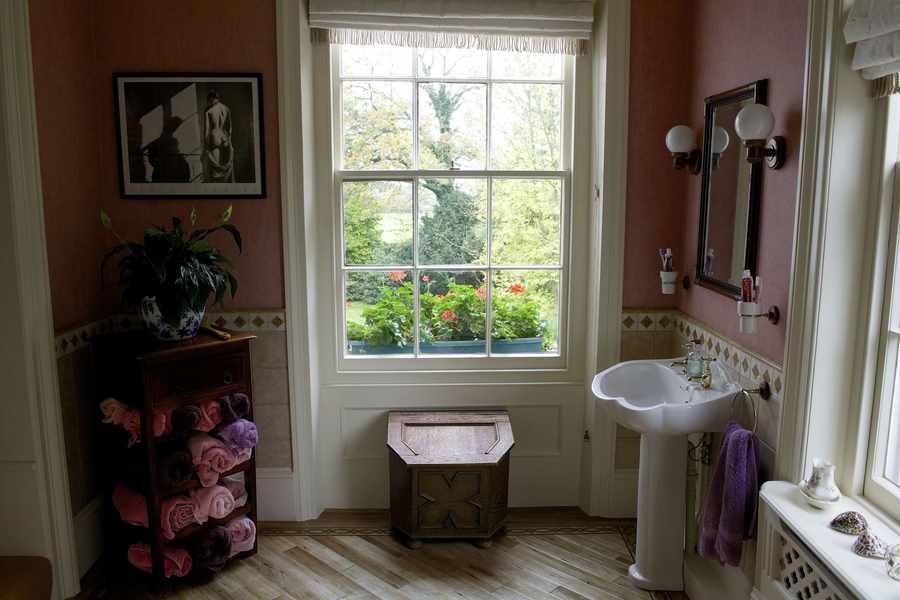 The bathroom features period furniture