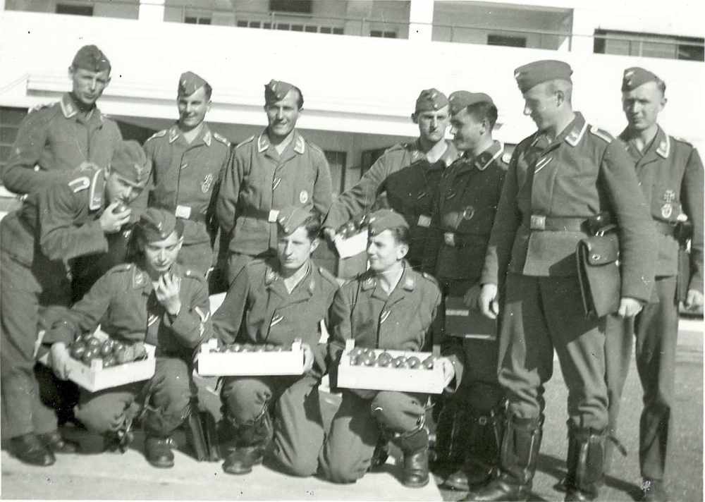 Airmen of the German Luftwaffe pose for a picture at the Airport trying a taste of Jersey tomatoes