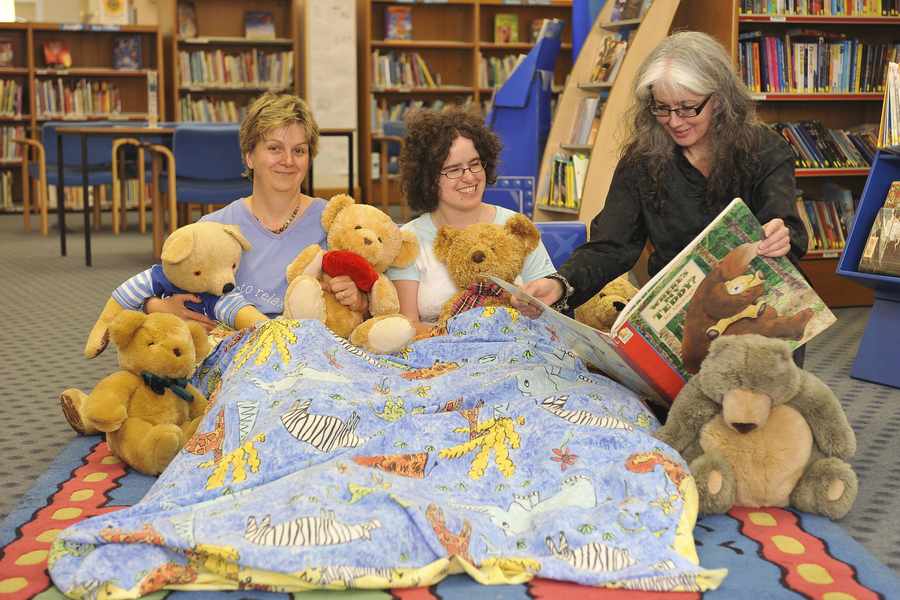 Senior librarian Linne Omissi pictured in 2010 promoting the Young Readers Service, reading to information assistants Pippa Dale (left) and Emma Vardon in the Young Readers Library.