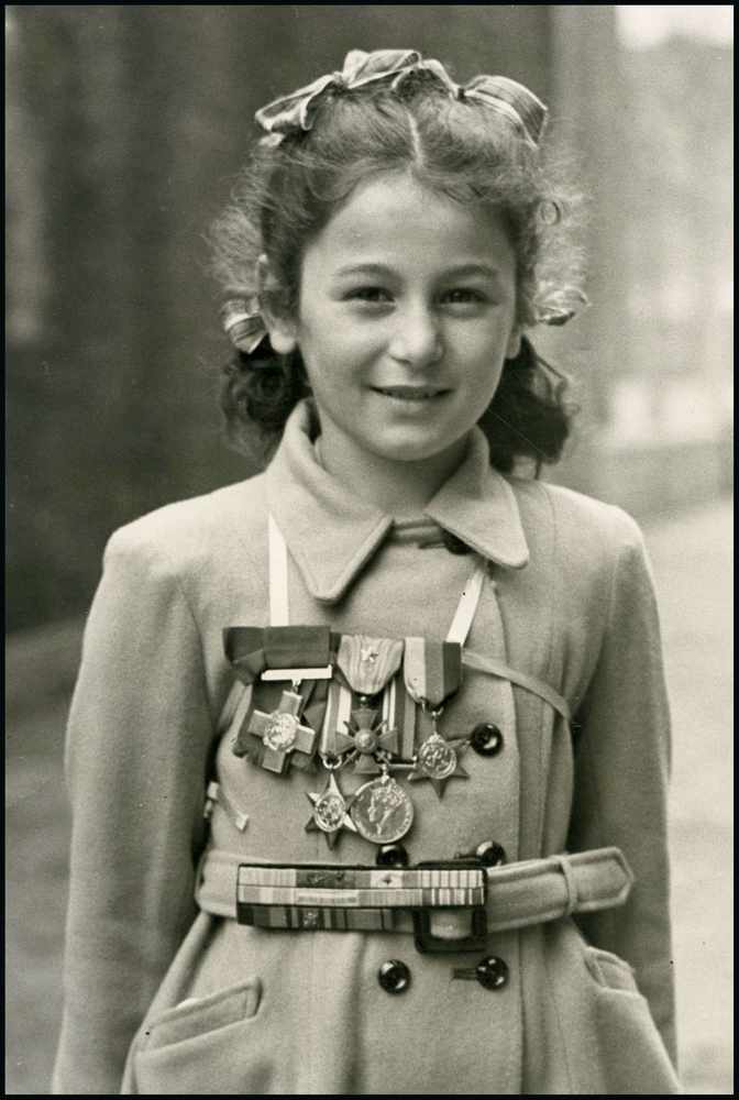 A young Tania Szabo wearing her mother's medals