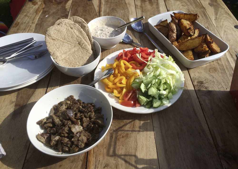 Lamb pittas, salad and Cajun potato wedges