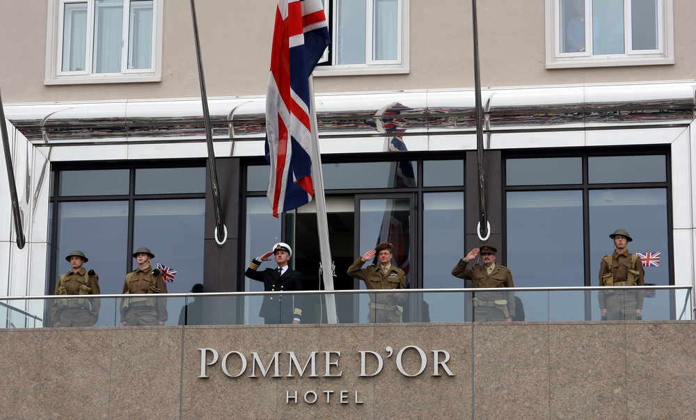 Raising the flag at the Pomme d'Or Hotel