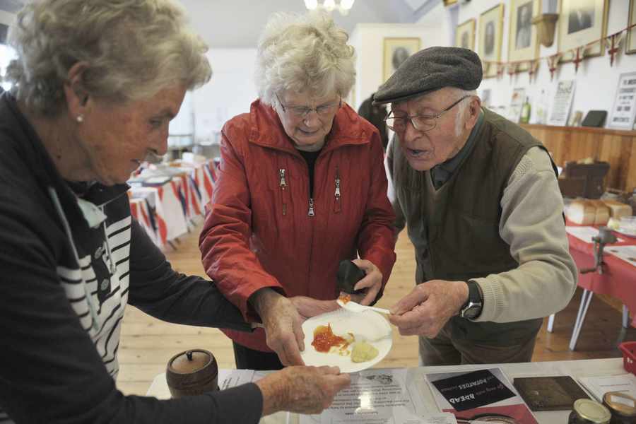 Yvonne Isherwood serves some parsnip honey and jam to Alice Huelin and John Huelin