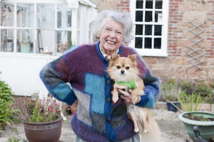 Mary Herold and Zippy outside her home in Grouville