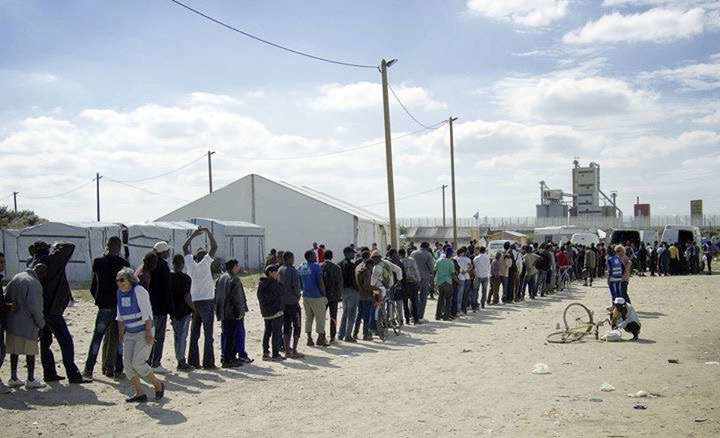 Refugees wait their turn to receive aid from the Jersey Calais Refugee Aid Group, which was set up by Jersey teacher Bram Wanrooij