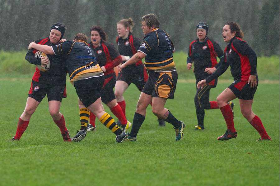 Cara Mackay holds off the challenge of one of Canterbury's prop forwards