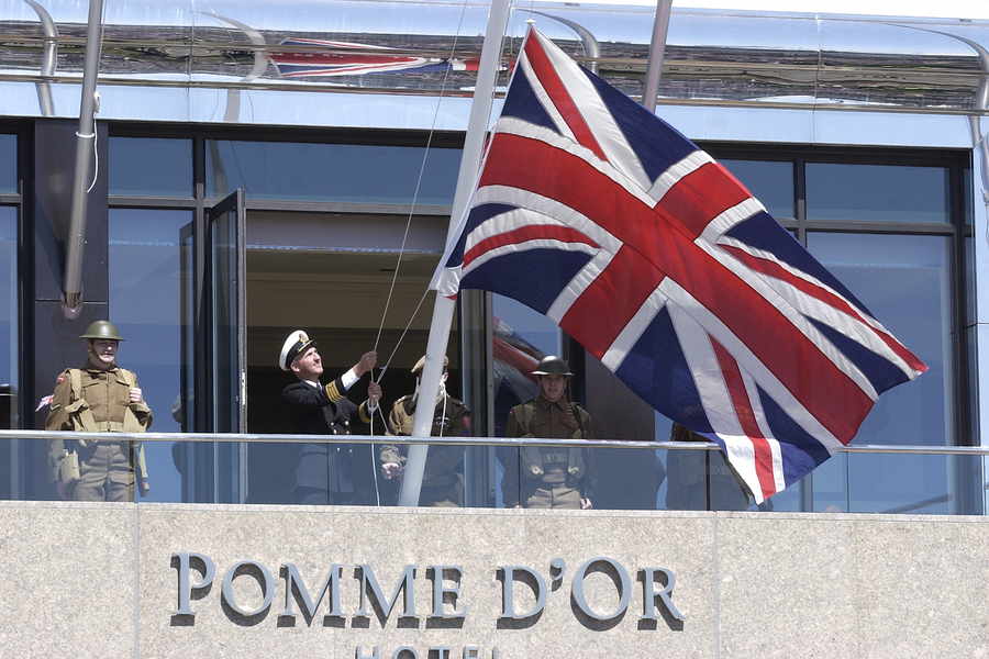 The flag is raised on Liberation Day during the re-enactment