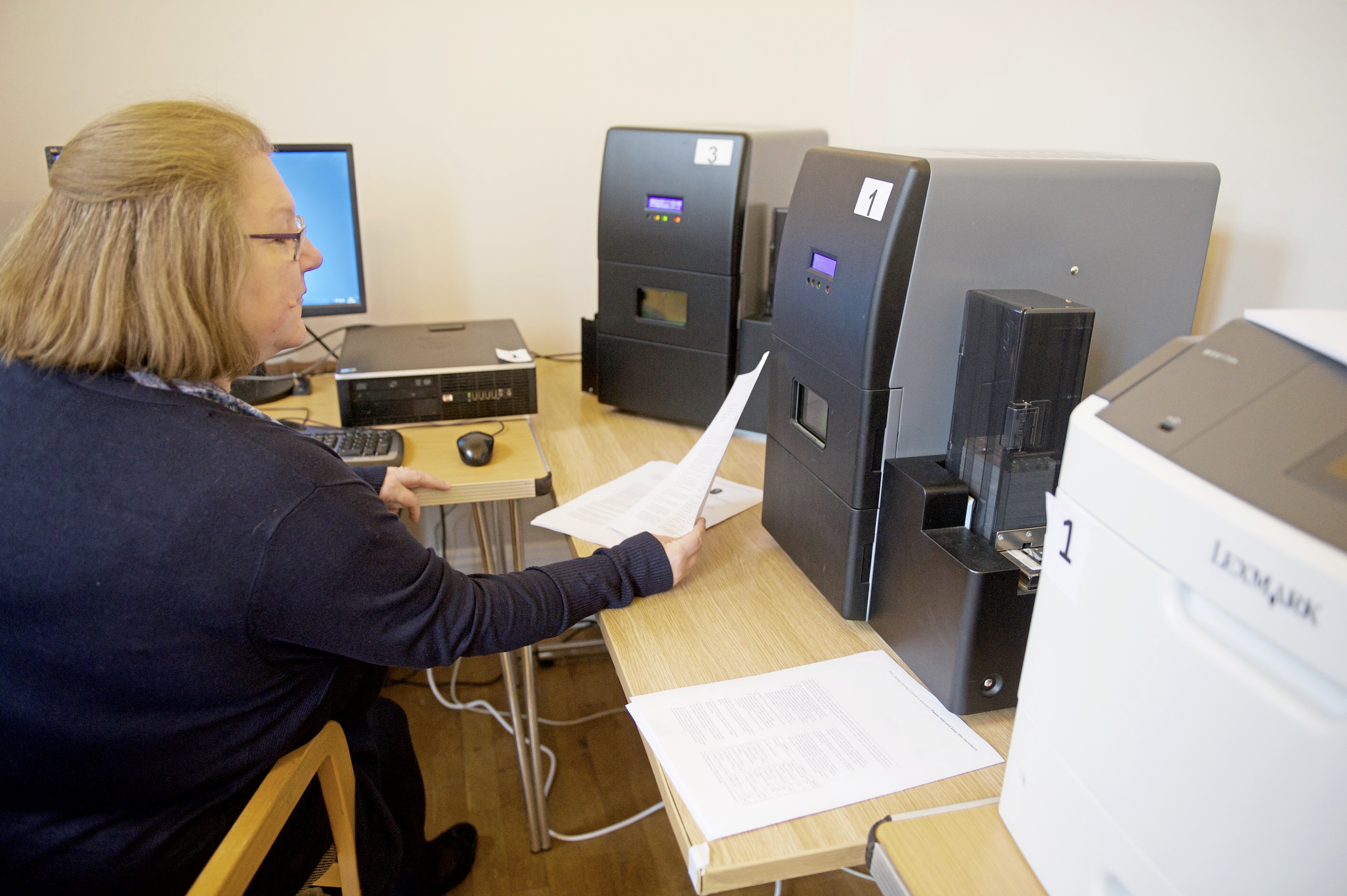Diane Bisson overseeing the printing of the licences on laser engraving machines at the Town Hall