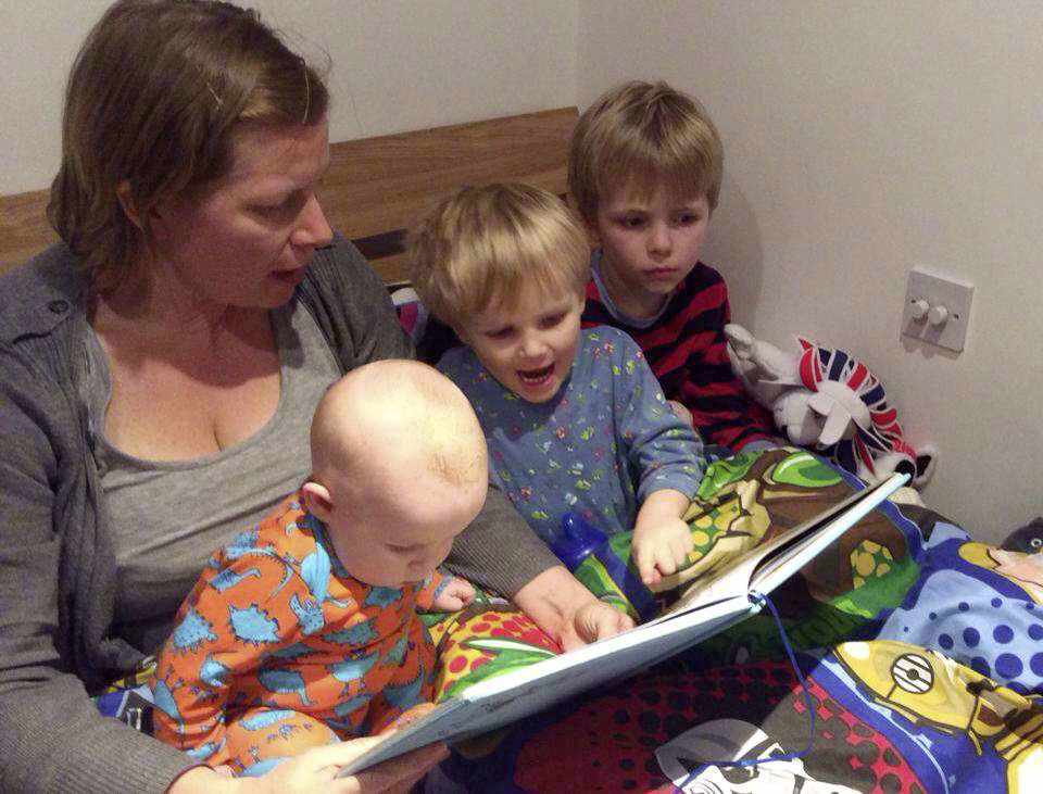Julie Pirouet reads bedtime stories to her children