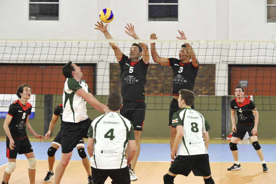 Matthew Morel and Leo Figueira look to block a Guernsey attack in the Men's A match